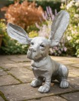 Digital Illustration of "Sid" the Bassett Hound Cast Aluminium Garden Sculpture on a Garden Patio with Sun Shining on Flowers in the Background