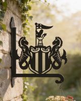 Digital illustration of Steel Newcastle United Crest Hanging Basket Bracket mounted on a garage