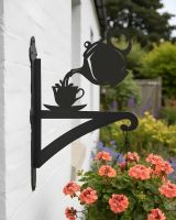 Digital illustration of Teapot & Cup Iron Hanging Basket Bracket mounted on garden cottage wall