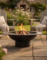 Digital Illustration of the 100cm Curved Steel Bowl Fire Pit Positioned in Front of Garden Lounge Chairs