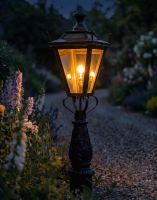 Digital Illustration of the 105cm Antique Brass Dorchester Driveway Light Positionel on a Flowery Gravel Entrance Whilst Lit up at Night