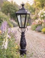 Digital Illustration of the 105cm Black Dorchester Driveway Light Placed on a Flowery Gravel Entranceway