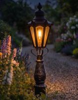 Digital Illustration of the 105cm Concordia Patio Garden Balustrade or Driveway Lighting Placed on a Flowery Gravel Driveway and Lit up at Night