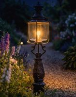 Digital Illustration of the 112cm Belgravia Driveway Light Positioned on a Flowery Gravel Entranceway Whilst Lit up at Night 