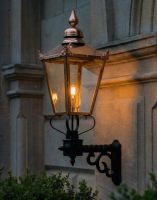 Digital Illustration of the 115 x 51cm Copper Wall Lantern on a Royale Bracket lit up at Night