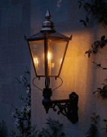 Digital Illustration of the 115 x 65cm Copper Wall Lantern on an Ornate Bracket Lit up at Night