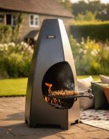 Digital Illustration of the 120cm Tall Wide Curved Chimenea With Swing Arm Grill Positioned in a Sunny Garden with Skewers Cooking over the Fire