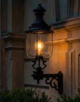 Digital Illustration of the 150 x 51cm Belgravia Lantern and Royale Bracket Lit up at Night 