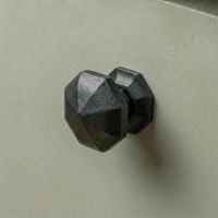 Digital Illustration of the 32mm Steel Beeswax Octagonal Cabinet Knob on a Sage Green Cupboard Door