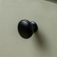 Digital Illustration of the 32mm Steel Powder Coated Cabinet Knob Mounted on a Green Cupboard Door