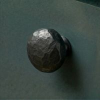 Digital Illustration of the 38mm Black Hammered Steel Cabinet Knob Mounted on a Blue Cupboard Door