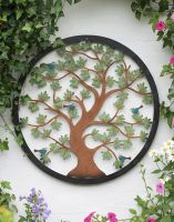 Digital Illustration of the 60cm Version of the Multi-Coloured Circular "Tree of Life" Garden Wall Art on the Side of a White Garden Building