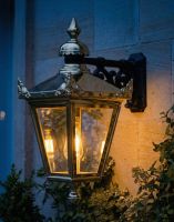 Digital Illustration of the 63 x 47.5cm Version of the Polished Brass Suspended Wall Lantern Lit up at Night.jpg