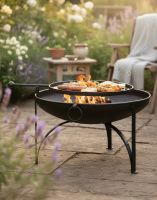 Digital Illustration of the 70cm Simple "Plain Jane" Fire Bowl with Swing Arm and Barbecue Rack Positioned in a Country Garden whilst Fully Lit