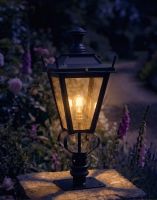 Digital Illustration of the 71cm Black Dorchester Pillar Light and Lantern Set Mounted on a Stone Garden Pillar Surrounded by Flowers lit up at Night