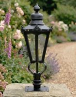 Digital Illustration of the 76cm Black Hexagonal Pillar Light and Lantern Set Mounted on a Stone Pillar in a Garden Viewed from an Angle