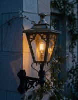 Digital Illustration of the 84 x 37cm Brass Gothic Wall Lantern on a Corner Bracket Lit up at Night