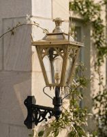 Digital Illustration of the 84 x 37cm Brass Gothic Wall Lantern on a Corner Bracket Mounted on a Sandstone Brick Sunny Garden Wall