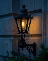 Digital Illustration of the 88 x 33cm Black Hexagonal Lantern on a Royale Bracket Lit up at Night