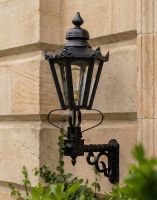 Digital Illustration of the 88 x 33cm Black Hexagonal Lantern on a Royale Bracket Mounted on a Sandstone Brick Traditional Home