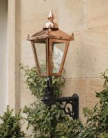 Digital Illustration of the 88 x 33cm Copper Wall Lantern on a Royale Bracket Mounted on a Sandstone Brick Building