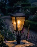Digital Illustration of the 90cmBlack Dorchester Pillar Light and Lantern Set Mounted on a Stone Garden Pillar Whilst Lit up at Night 