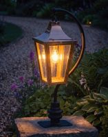 Digital Illustration of the 96cm Copper Swan Neck Pillar & Lantern Mounted on a Stone Garden Wall Pillar and Lit up at Night