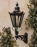 Digital Illustration of the 98 x 46cm Black Hexagonal Wall Lantern on an Ornate Bracket Mounted on a Limestone Brick Garden Wall 