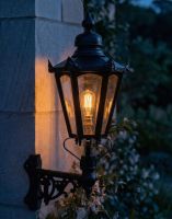 Digital Illustration of the 98 x 46cm Black Hexagonal Wall Lantern on Corner Bracket Lit up at Night