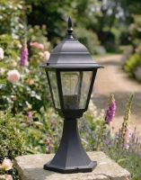 Digital Illustration of the Black "Chelsea" Traditional Pillar Light Mounted on a Stone Garden Pillar Surrounded by Flowers