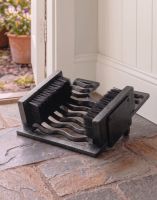 Digital Illustration of the BlackThree-in-One Boot Jack, Boot Brush & Scraper Placed on a Stone Floor Cottage Hallway
