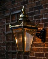 Digital Illustration of the Brass "Sunningdale" Lantern On Ornate Wall Bracket Illuminated at Night
