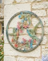 Digital Illustration of the Colourful Hummingbird Garden Wall Art Mounted on a Cottage Wall 