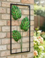 Digital Illustration of the Colourful Monstera Leaf Garden Wall Art Mounted on the Side of a Brick House