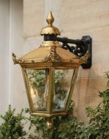 Digital Illustration of the Large 63 x 47.5cm Version of the Antique Brass Hanging Wall Lantern Mounted on a Sandstone Bricked Wall 