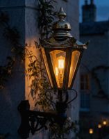 Digital Illustration of the Large Brass Concordia Hexagonal Lantern With a Corner Bracket Lit up at Night