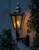 Digital Illustration of the Medium Concordia Hexagonal Brass Lantern On a Capella Bracket Lit up at Night