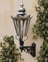 Digital Illustration of the Medium Concorida Hexagonal Polished Nickel Lantern On a Capella Bracket Mounted on a Traditional Sandstone Brick Wall