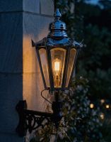 Digital Illustration of the Medium Polished Nickel Concordia Hexagonal Lantern On a Corner Bracket Lit up at Night