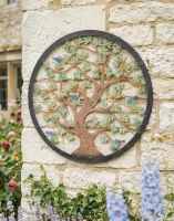 Digital Illustration of the Multi-Coloured Circular "Tree of Life" Garden Wall Art Mounted on the Side of a Cottage