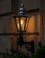 Digital Illustration of the Polished Nickel Standard Concordia Hexagonal Lantern On a Royale Bracket Lit up at Night
