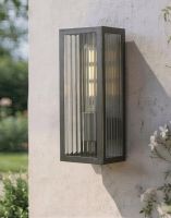 Digital Illustration of the Rubbed Bronze Reeded Glass Wall Light Fixed on a Sunny White Garden Wall