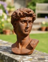Digital Illustration of the Rustic Cast Iron "Bust of David" Sculpture on a Garden Wall with a Sunny Garden Scene Behind
