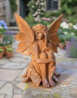 Digital Illustration of the Rustic Cast Iron "Winged Fairy" Garden Sculpture Placed on a Garden Wall