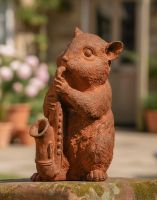 Digital illustration of the Rustic Cast Iron Saxophone Playing Chipmunk Sculpture on a Garden Wall with Rustic Cottage in Background