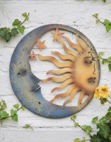 Digital Illustration of the Sun and Moon Garden Wall Art Mounted on White Brick Building