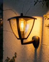 Digital Illustration of the Traditional Canopied Wall Light in a Black Finish Lit up at Night