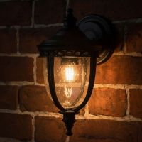 Digital representation of "Winsford" Traditional Top Fix Black Wall Lantern lit up at night