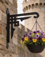 Digital representation of Art Deco Heavy Duty Iron Hanging Basket Bracket mounted in a walled garden