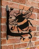 Digital representation of Bumblebee Hanging Basket Bracket mounted on a red brick wall